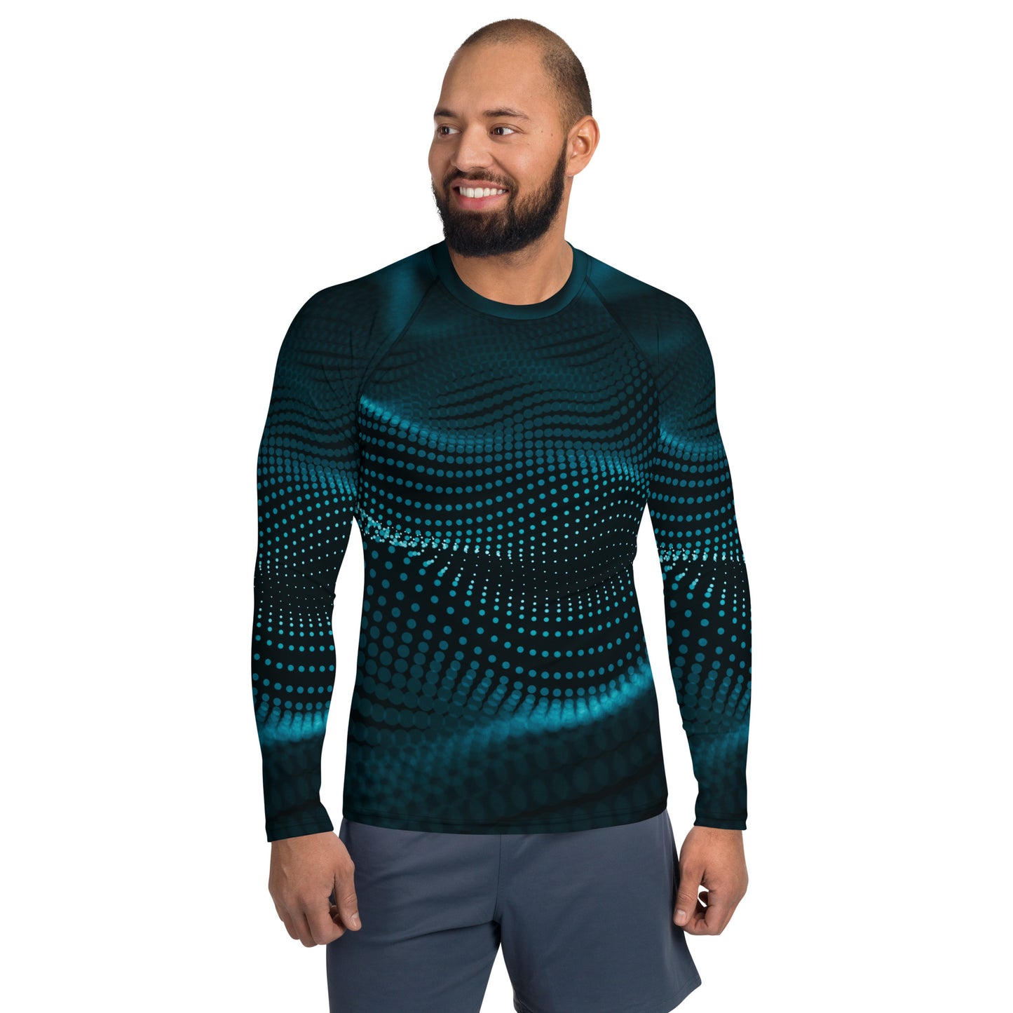 A man wearing a long-sleeved, solid blue sailing rash guard with a geometric pattern.
